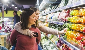 Women at supermarket shopping