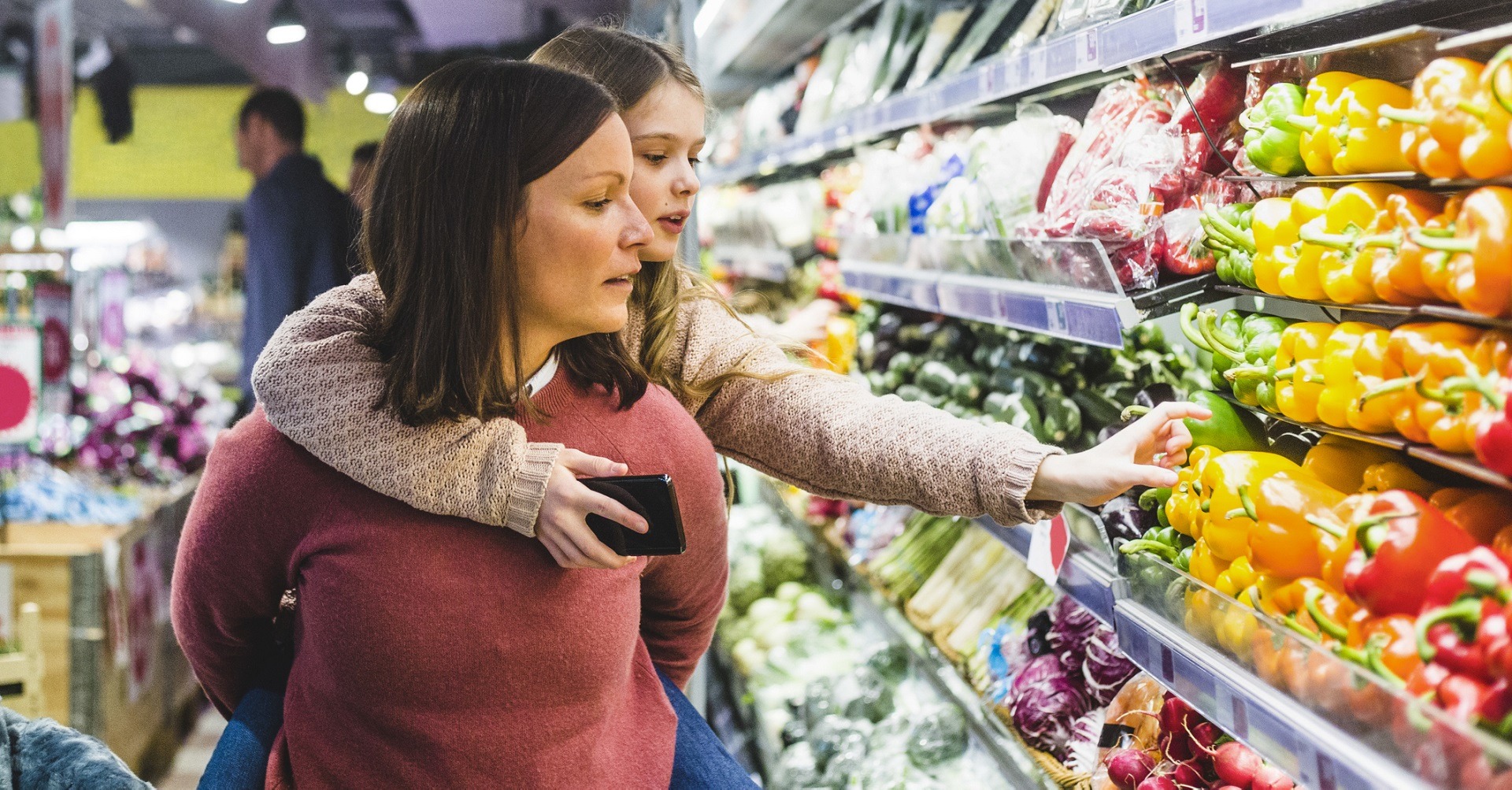 Women at supermarket shopping