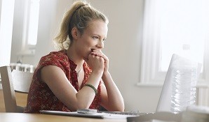 Woman sitting behind laptop online dating