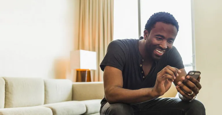 Man on cellphone sitting at home