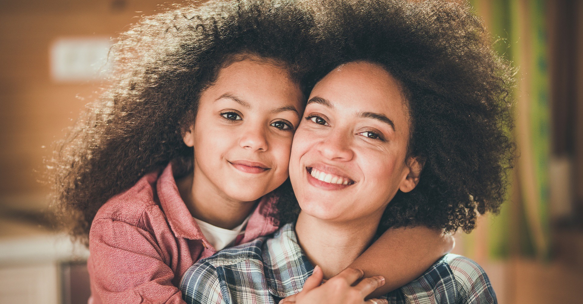Child hugging mother from behind