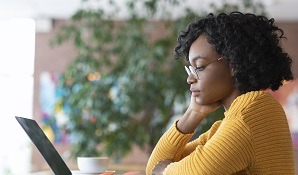 Woman looking at laptop thinking