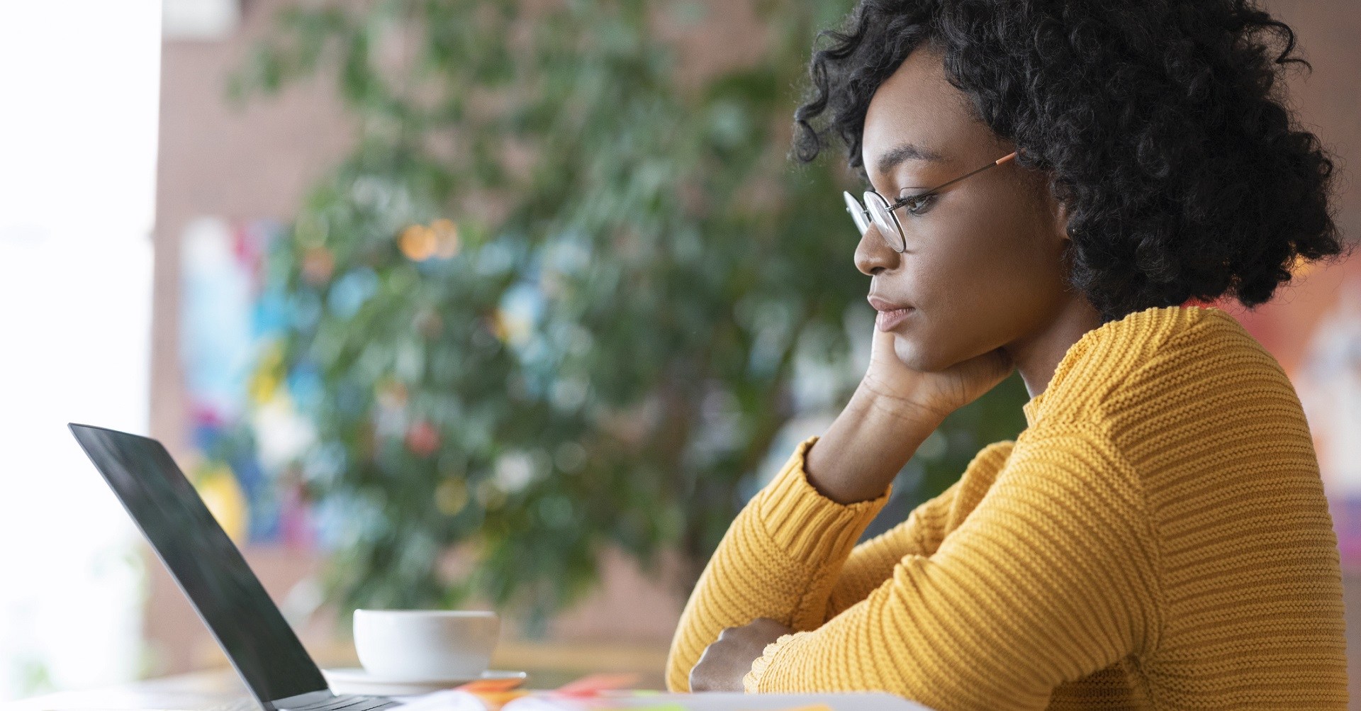 Woman looking at laptop thinking