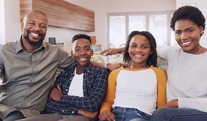 family sitting on couch at home