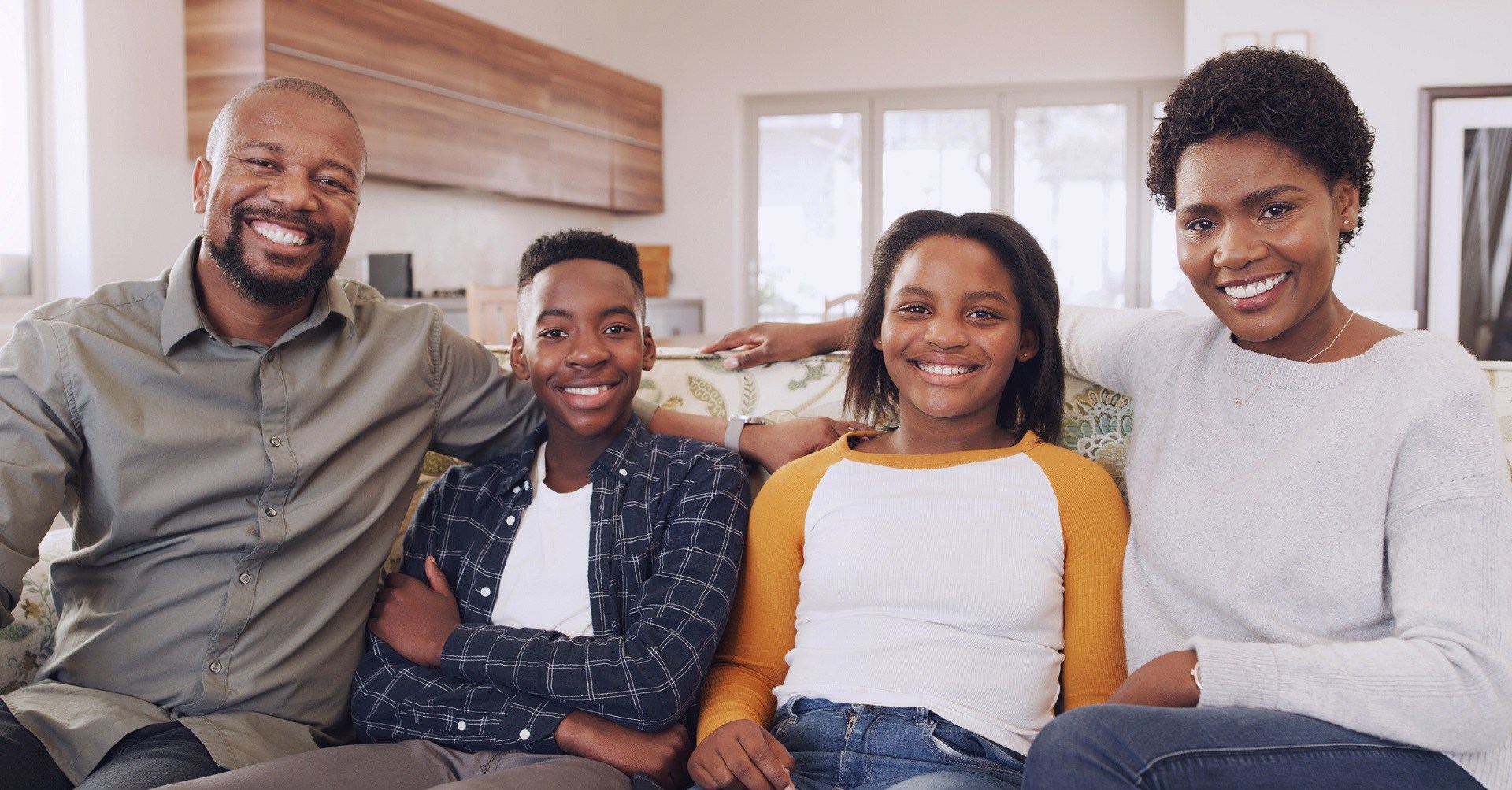 family sitting on couch at home