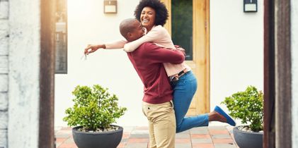 Couple hugging and celebrating their first home
