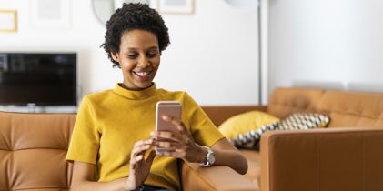 Woman looking at her smartphone and smiling