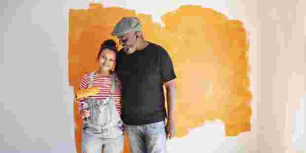 Dad and daughter painting house