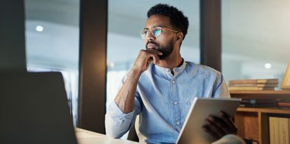 man sitting at desk thinking