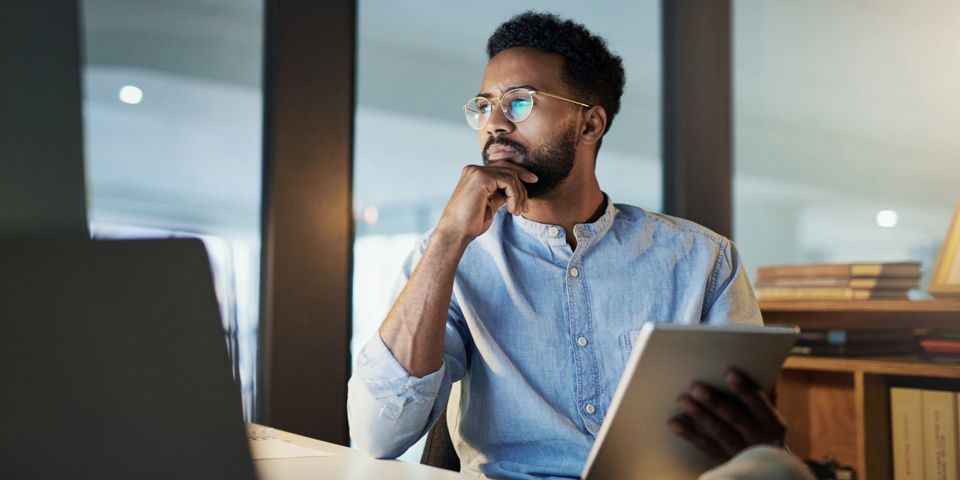 man sitting at desk thinking