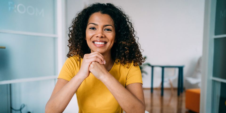 smiling lady sitting at desk