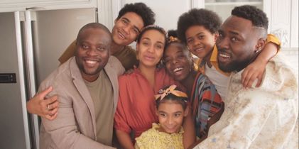 family hugging in kitchen