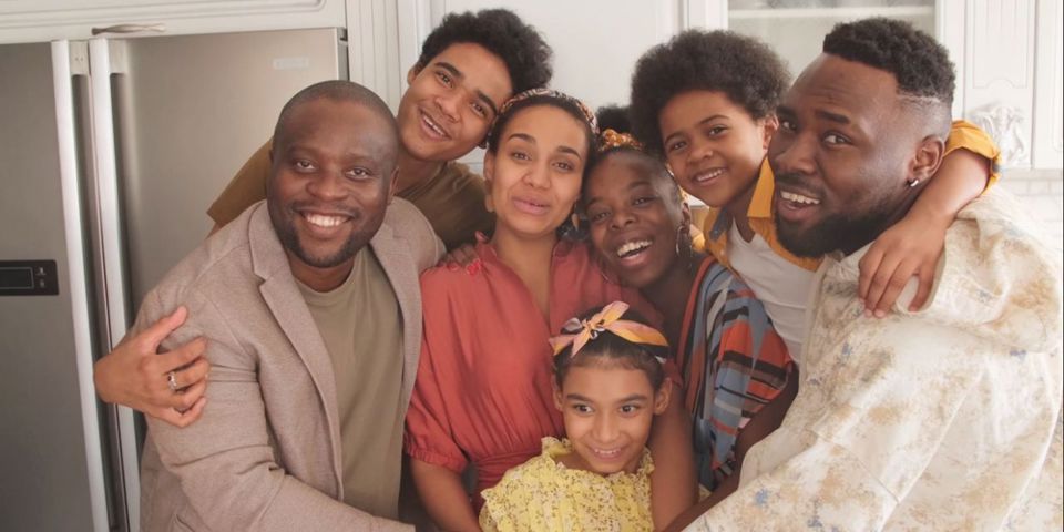 family hugging in kitchen