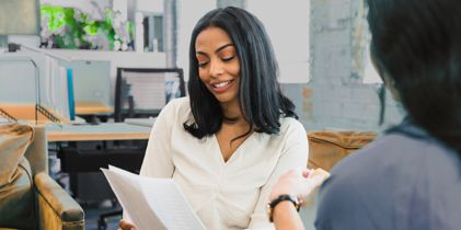 women discussing document