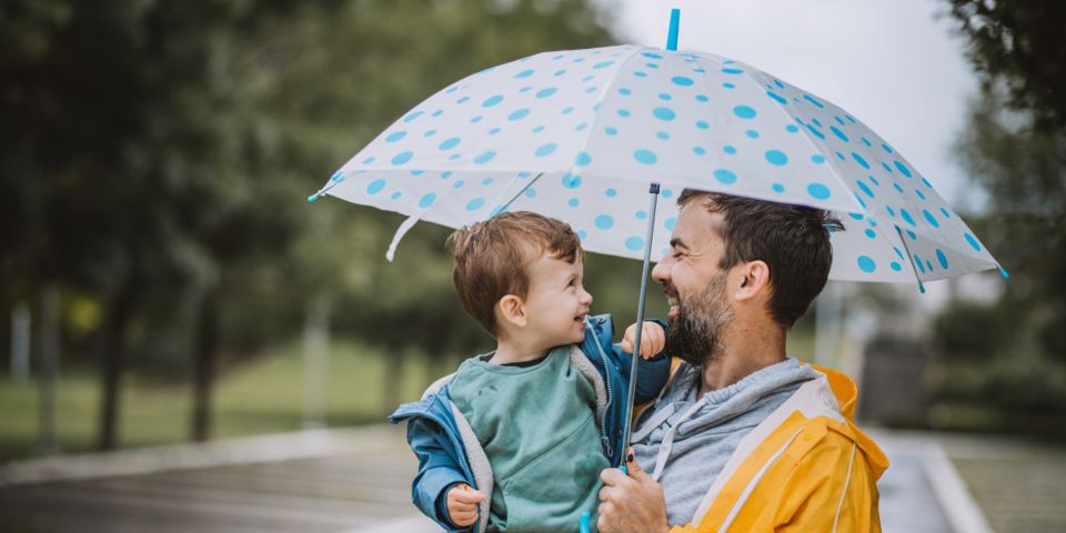 man with umbrella and toddler