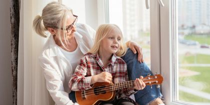 woman sitting in window with girl
