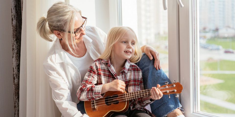 woman sitting in window with girl