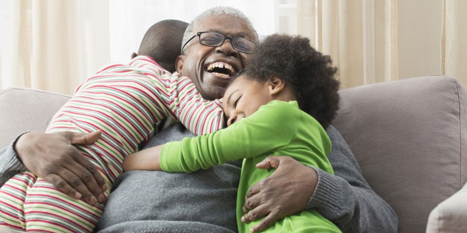 children hugging grandfather