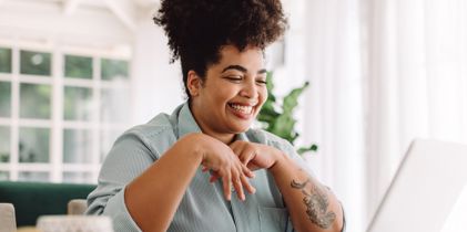 woman smiling at laptop