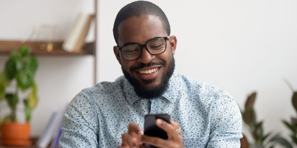 Man on his phone smiling