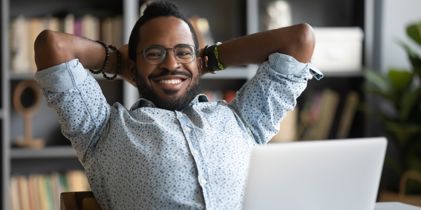 Smiling man with hands behind his head 