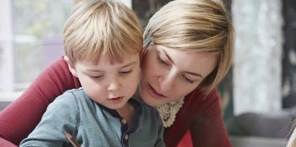 Son learning with his mother