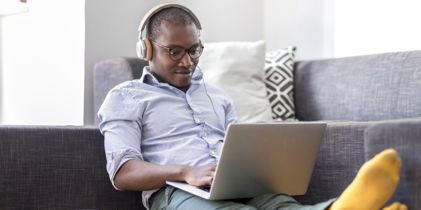 Man with headphones on laptop
