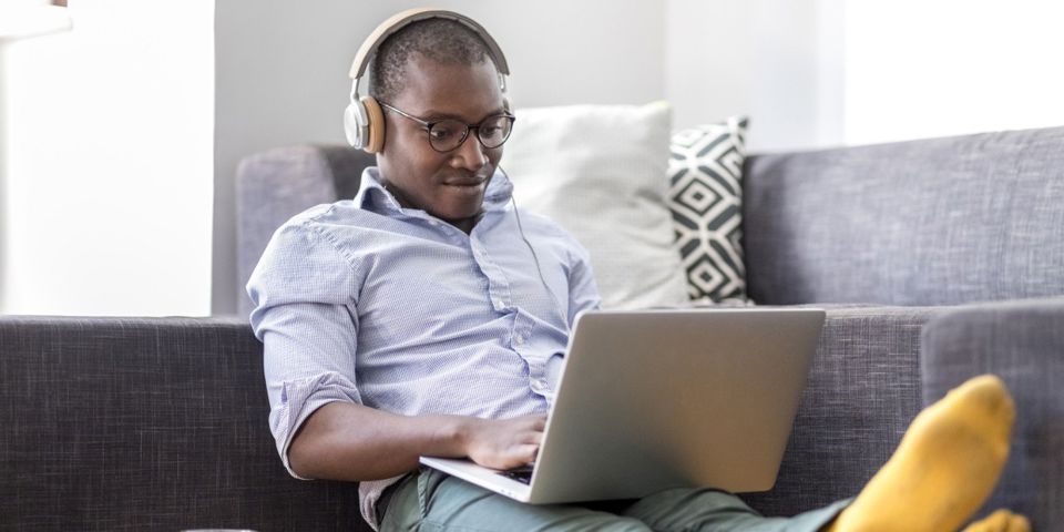 Man with headphones on laptop