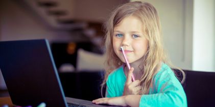 Child sitting in front of laptop