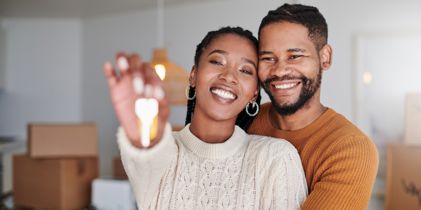 Couple holding key to new home