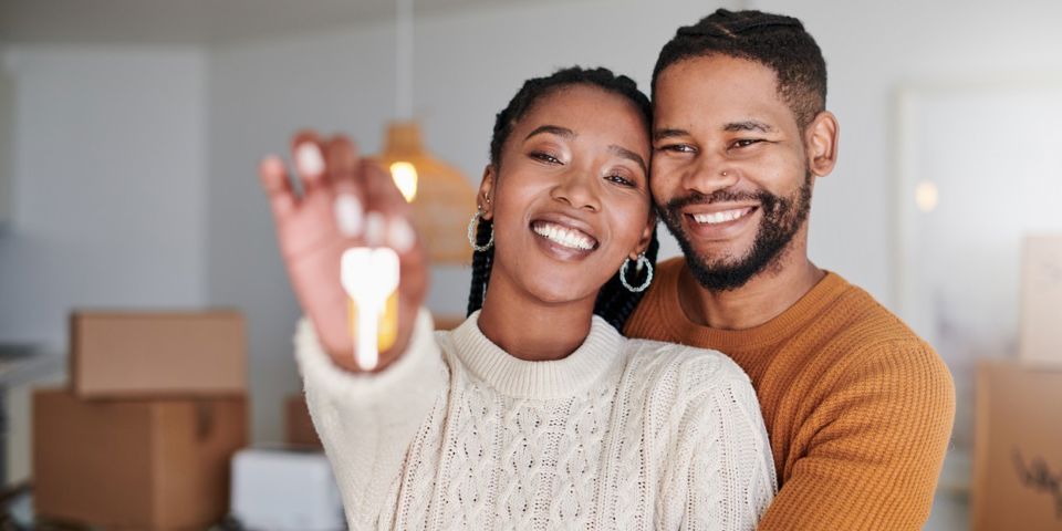 Couple holding key to new home