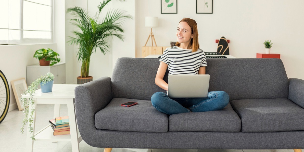 Woman sitting on a couch with her laptop