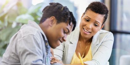 Mother helping child with homework