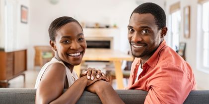 Couple sitting on the couch and smiling