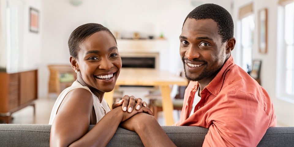 Couple sitting on the couch and smiling