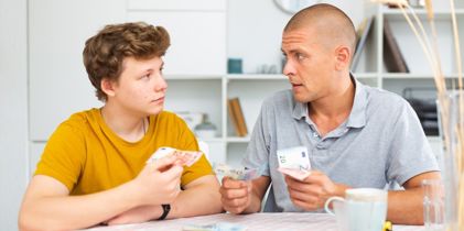 Father giving son pocket money