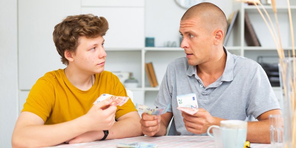 Father giving son pocket money