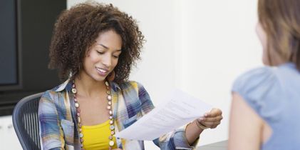 Lady looking at document and smiling