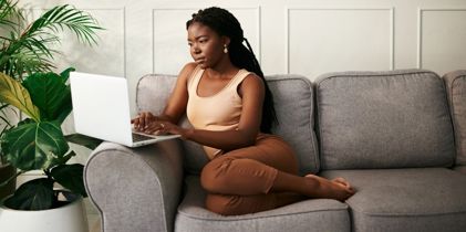 Woman on couch with laptop