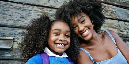 Mother and daughter smiling