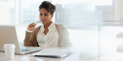 woman sitting at desk using laptop
