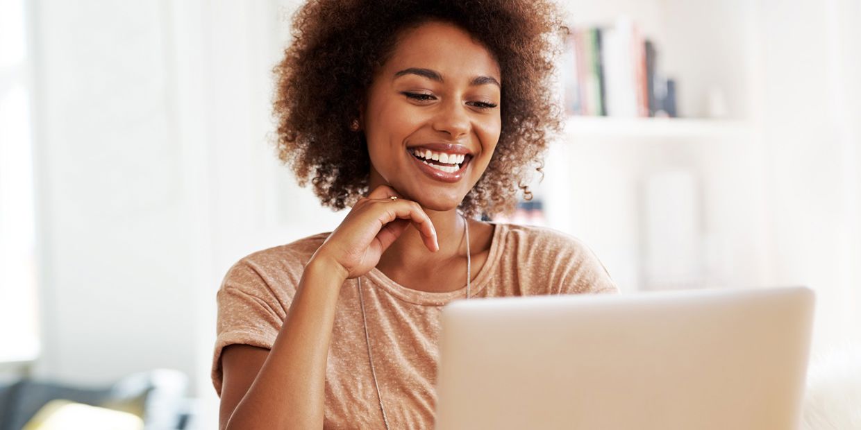 smiling woman looking at screen