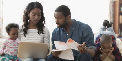 family on couch looking over documents