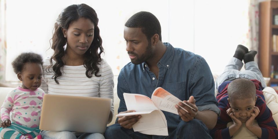 family on couch looking over documents