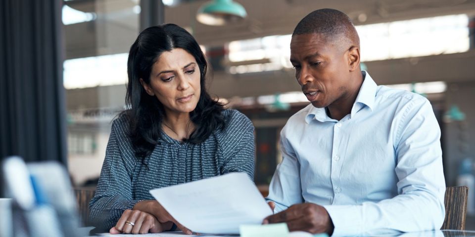 two people discussing document
