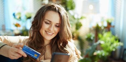 woman holding card and phone