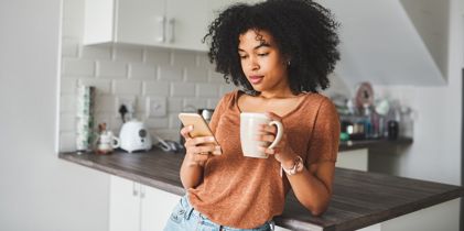 Woman on phone in kitchen