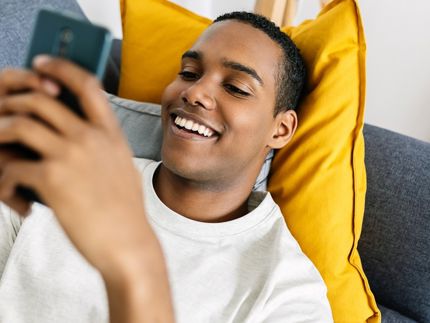 Young man on couch with cellphone