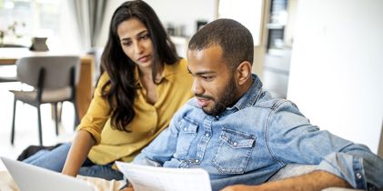 Couple on couch on laptop