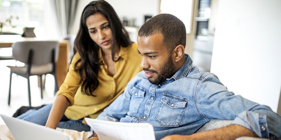 Couple on couch on laptop